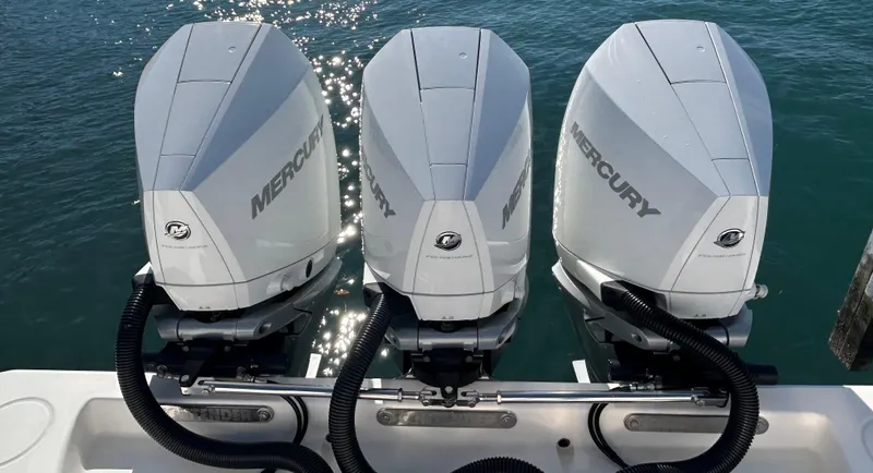  Yacht Photos Pics Triple Mercury outboard engines on a 2022 Contender 35 ST boat, glistening in sunlight.