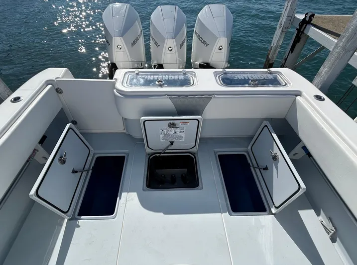  Yacht Photos Pics 2022 Contender 35 ST boat with open storage compartments and Mercury engines.