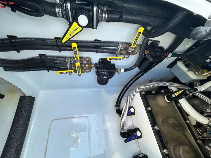 Yacht Photos Pics Engine compartment of a 2022 Contender 35 ST boat, showcasing hoses and valves.