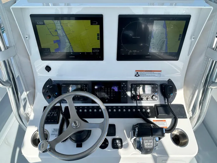  Yacht Photos Pics 2022 Contender 35 ST boat dashboard with dual navigation screens and steering wheel.