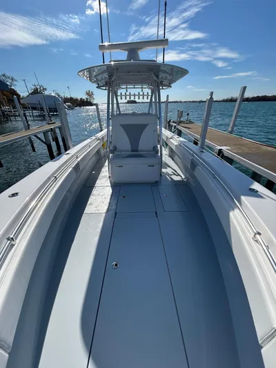  Yacht Photos Pics 2022 Contender 35 ST boat docked by the water under a clear blue sky.