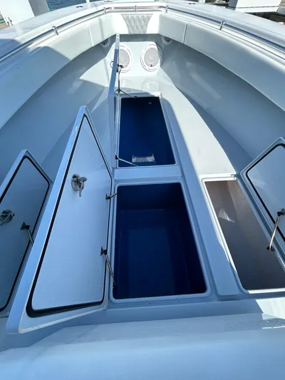  Yacht Photos Pics 2022 Contender 35 ST boat with open storage compartments and sleek design.