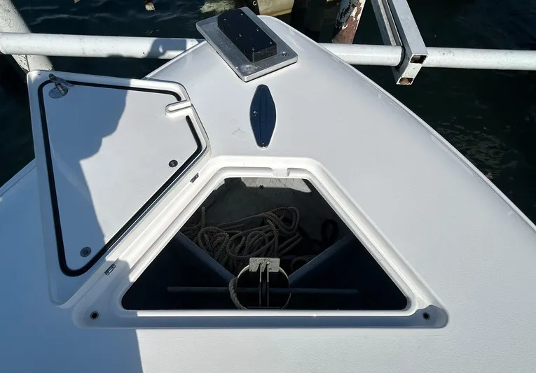  Yacht Photos Pics 2022 Contender 35 ST boat anchor compartment with open hatch, docked by the water.