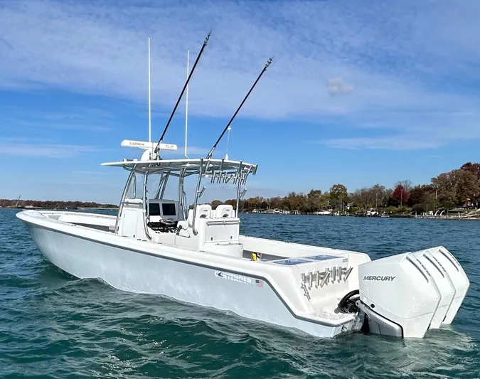  Yacht Photos Pics 2022 Contender 35 ST boat with twin Mercury engines on a calm lake.