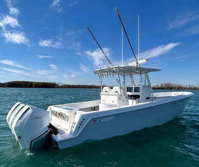  Yacht Photos Pics 2022 Contender 35 ST boat on clear blue water under a sunny sky.