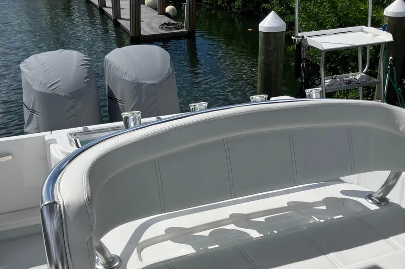  Yacht Photos Pics 2016 Contender 30 ST boat with covered engines docked by water.