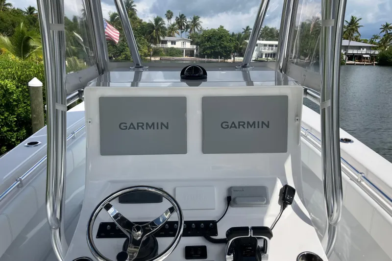  Yacht Photos Pics 2016 Contender 30 ST boat dashboard with dual Garmin displays, steering wheel, and controls.