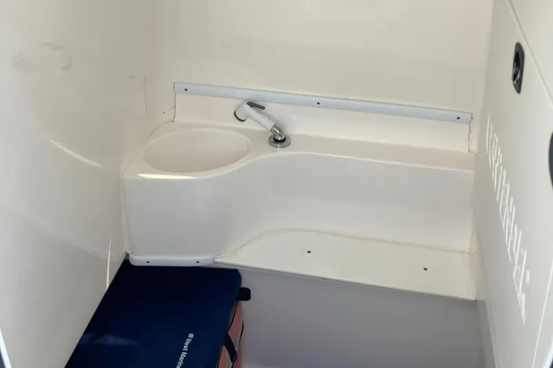  Yacht Photos Pics 2016 Contender 30 ST boat interior with compact sink and seating area.