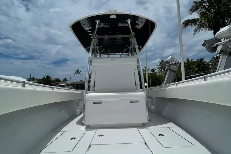  Yacht Photos Pics 2016 Contender 30 ST boat with sleek white interior and T-top under cloudy sky.