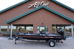2025 Tracker Bass Tracker Classic XL boat displayed outside a wooden building.