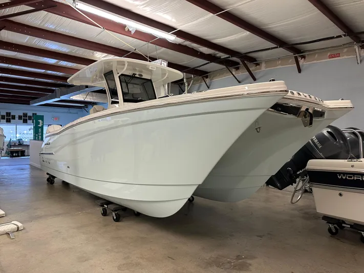 Wcn 55877 280ccx Yacht Photos Pics 2025 World Cat 280 CCX boat in a warehouse, showcasing sleek design and modern features.