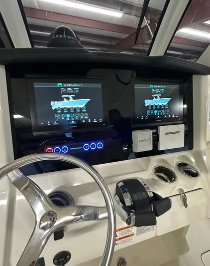 Wcn 55877 280ccx Yacht Photos Pics 2025 World Cat 280 CCX boat dashboard with dual touchscreen displays and steering wheel.
