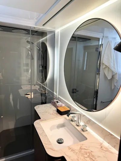  Yacht Photos Pics Luxurious bathroom in 2023 Azimut Magellano 66 yacht with modern fixtures and elegant design.
