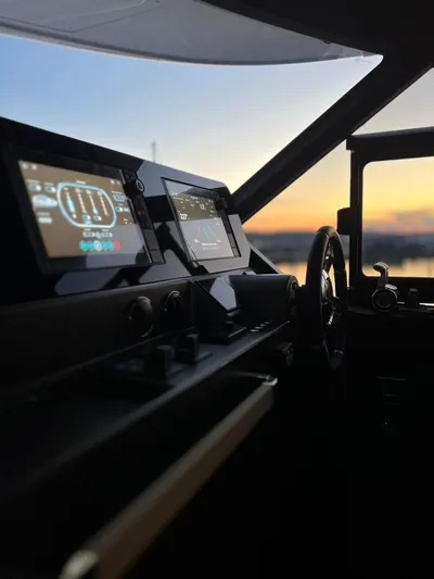  Yacht Photos Pics Cockpit of 2023 Azimut Magellano 66 yacht at sunset, featuring modern navigation displays.