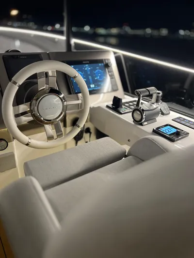  Yacht Photos Pics Helm of 2023 Azimut Magellano 66 yacht, featuring modern controls and illuminated dashboard at night.
