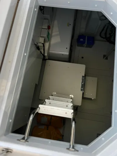  Yacht Photos Pics Hatch interior of 2023 Azimut Magellano 66 yacht, featuring a ladder and storage area.