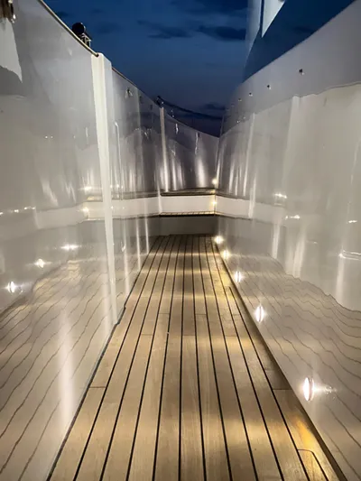  Yacht Photos Pics Azimut Magellano 66 yacht deck, 2023 model, illuminated at night with sleek design.