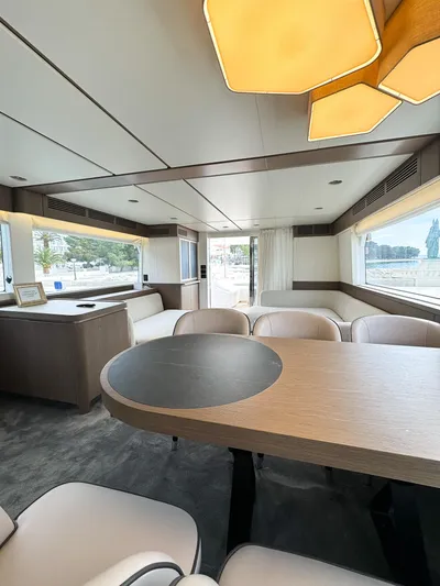  Yacht Photos Pics Luxurious interior of 2023 Azimut Magellano 66 yacht with modern dining area and panoramic windows.
