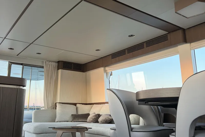  Yacht Photos Pics Luxurious interior of 2023 Azimut Magellano 66 yacht with modern furnishings and large windows.