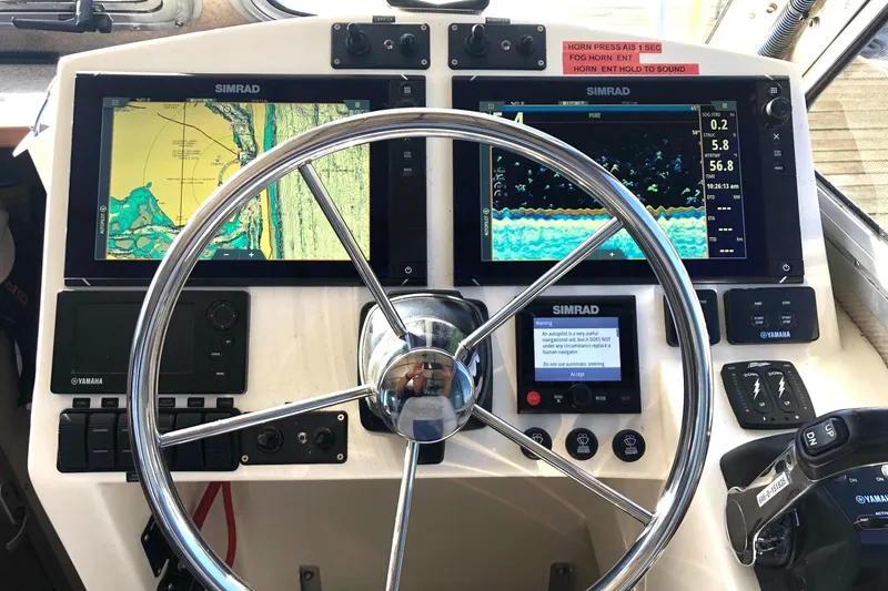  Yacht Photos Pics Control panel of a 2017 Osprey 30 Fisherman boat with Simrad navigation displays.