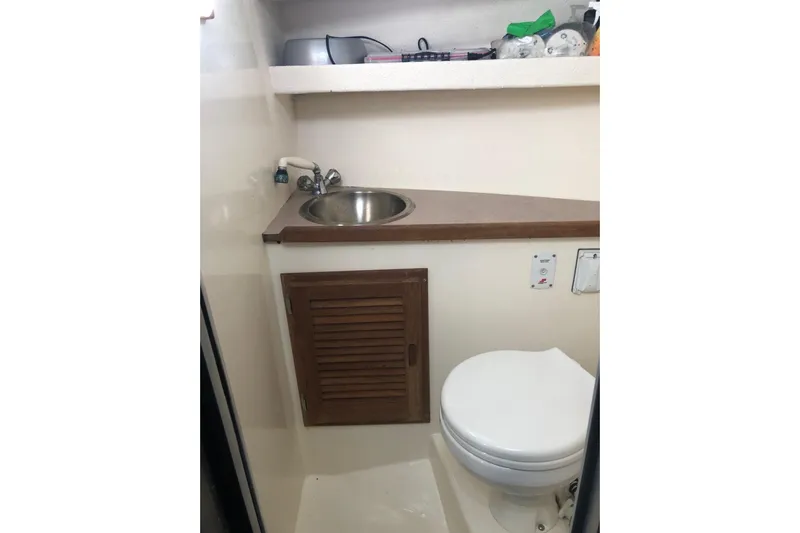  Yacht Photos Pics Compact bathroom in 2017 Osprey 30 Fisherman boat with sink and toilet.