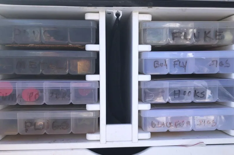  Yacht Photos Pics Tackle boxes labeled for fishing gear storage on a 2017 Osprey 30 Fisherman boat.