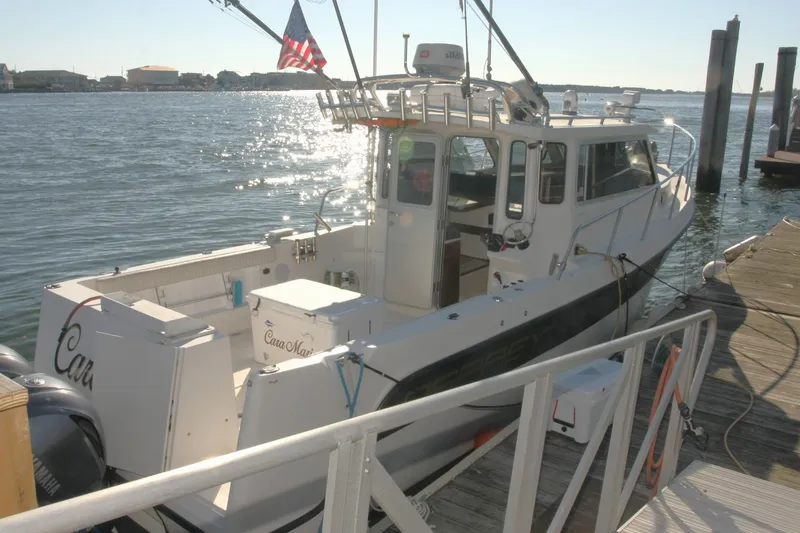  Yacht Photos Pics 2017 Osprey 30 Fisherman boat docked by the water, with American flag.