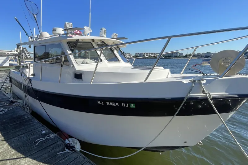  Yacht Photos Pics 2017 Osprey 30 Fisherman boat docked, featuring fishing gear and sleek design.