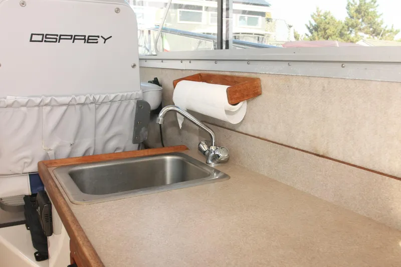  Yacht Photos Pics Interior of 2017 Osprey 30 Fisherman boat with sink and paper towel holder.