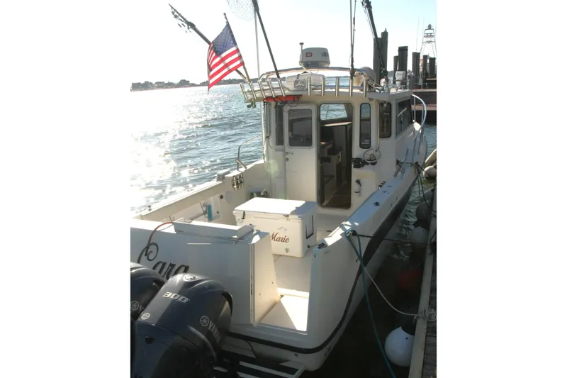  Yacht Photos Pics 2017 Osprey 30 Fisherman boat docked, featuring dual engines and American flag.