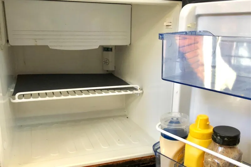  Yacht Photos Pics Empty refrigerator interior with condiments on the door shelf, Osprey 30 Fisherman, 2017 model.