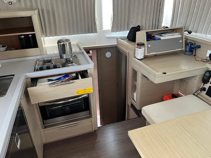  Yacht Photos Pics Interior of 2023 Lagoon 40 yacht with modern kitchen and seating area.