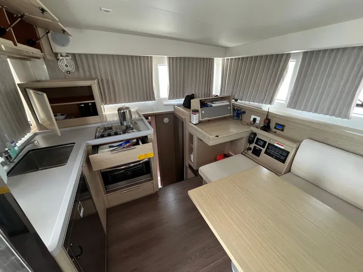  Yacht Photos Pics Modern interior of 2023 Lagoon 40 yacht with kitchen and dining area.