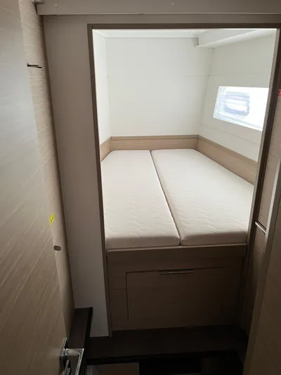  Yacht Photos Pics 2023 Lagoon 40 cabin interior with bed and window.