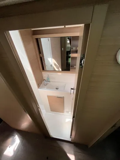  Yacht Photos Pics 2023 Lagoon 40 yacht bathroom with modern sink and mirror.