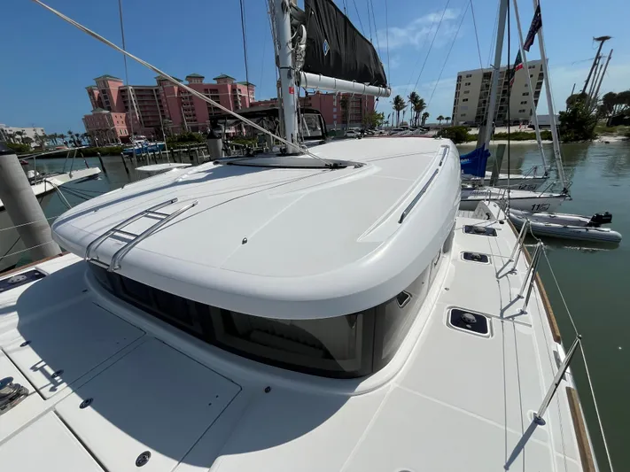 Yacht Photos Pics 2023 Lagoon 40 catamaran docked in marina, showcasing sleek design and modern features.