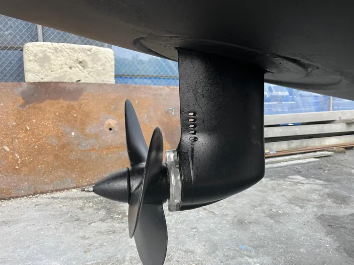  Yacht Photos Pics Close-up of a 2023 Lagoon 40 boat propeller and rudder in a shipyard.