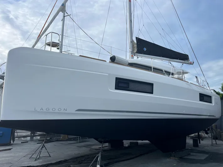  Yacht Photos Pics 2023 Lagoon 40 catamaran on land, showcasing sleek design and modern features.