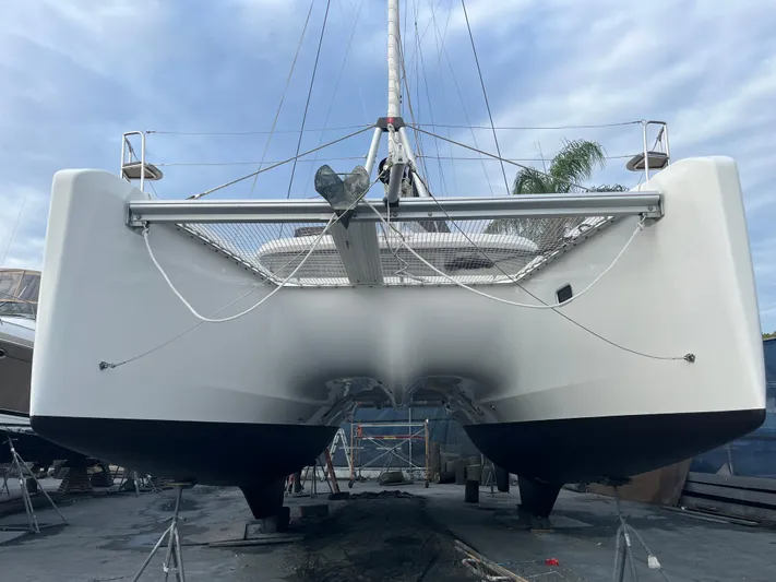  Yacht Photos Pics 2023 Lagoon 40 catamaran on dry dock, showcasing sleek hull design.