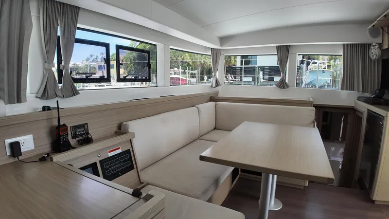  Yacht Photos Pics Interior of 2023 Lagoon 40 catamaran with modern seating and large windows.
