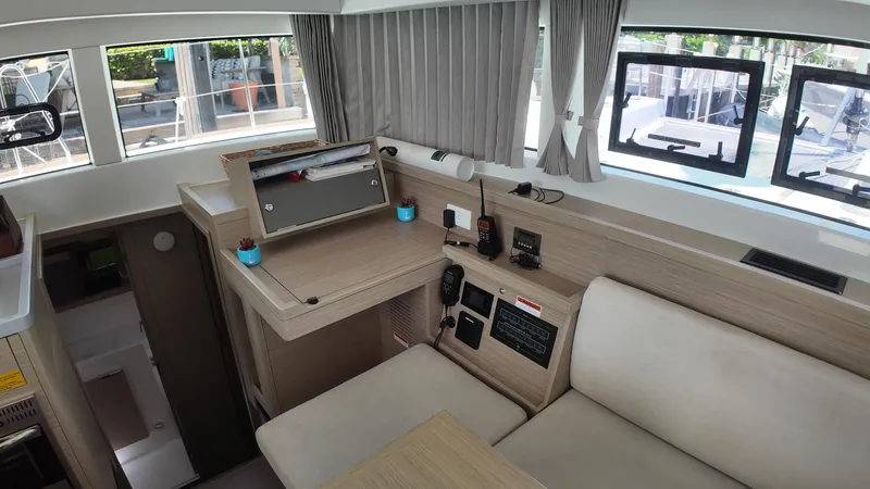  Yacht Photos Pics Interior of 2023 Lagoon 40 catamaran with modern navigation equipment and comfortable seating.