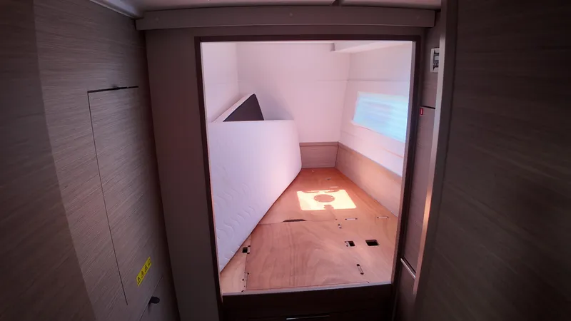  Yacht Photos Pics 2023 Lagoon 40 interior cabin with wooden finish and window.