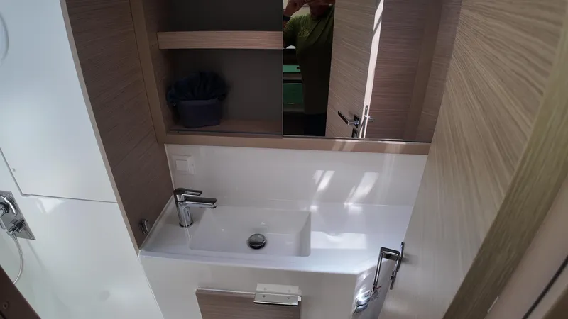  Yacht Photos Pics Modern bathroom interior of 2023 Lagoon 40 yacht with sleek sink and mirror.