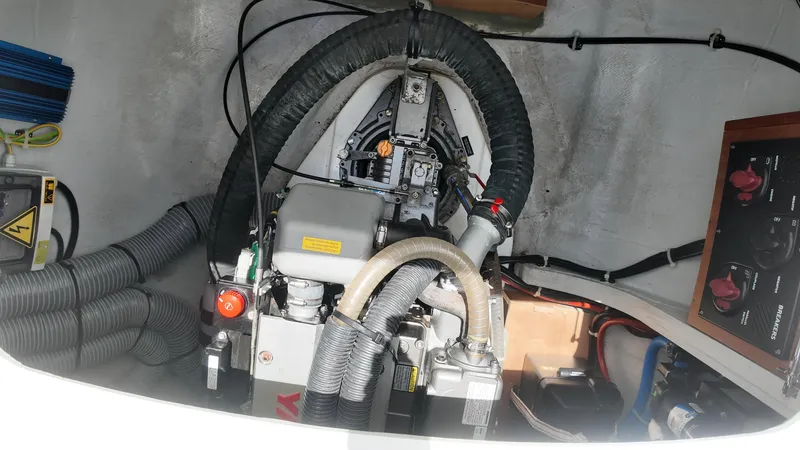  Yacht Photos Pics Engine compartment of a 2023 Lagoon 40 catamaran, featuring hoses and control panel.