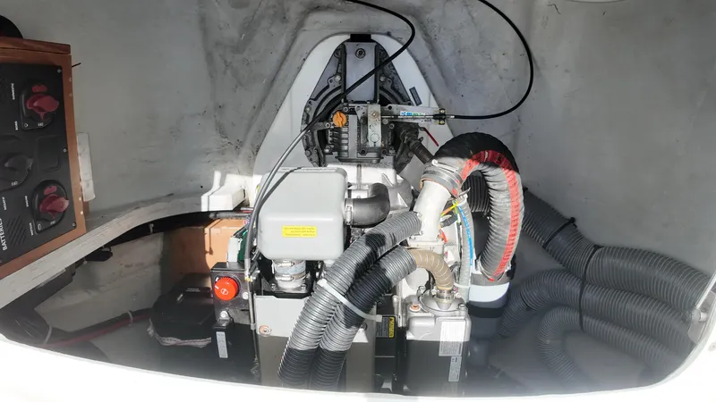  Yacht Photos Pics Engine compartment of a 2023 Lagoon 40 catamaran, showcasing mechanical components and wiring.