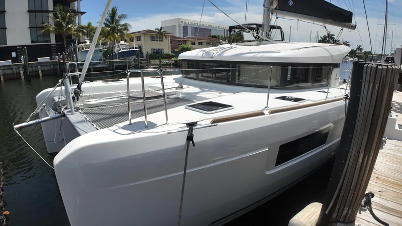  Yacht Photos Pics 2023 Lagoon 40 catamaran docked at marina, showcasing sleek design and modern features.