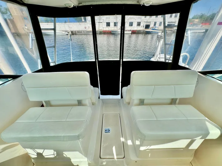 Castaways Yacht Photos Pics Interior of 2006 Tiara Yachts 29 Open with white seating and waterfront view.