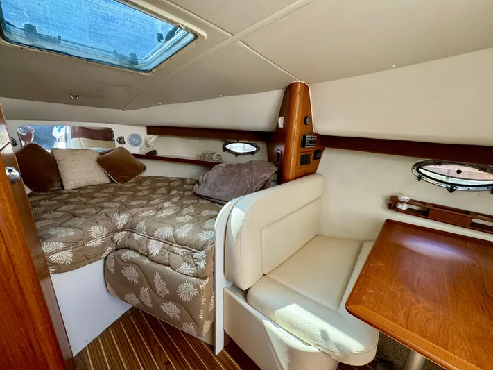 Castaways Yacht Photos Pics Interior of 2006 Tiara Yachts 29 Open, featuring cozy cabin with bed and seating area.