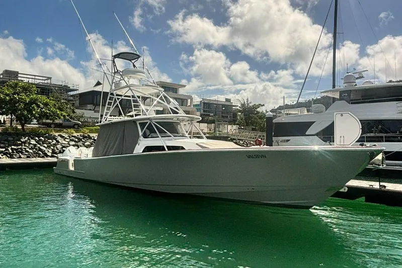 Yacht Photos Pics 2024 Valhalla Boatworks V-55 docked in a marina under a partly cloudy sky.