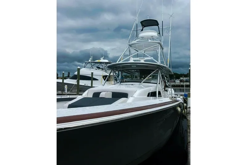 Yacht Photos Pics 2024 Valhalla Boatworks V-55 yacht docked under cloudy skies.
